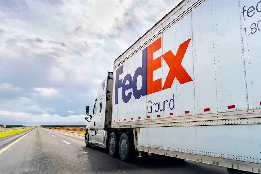 FedEx ground freight truck driving down highway